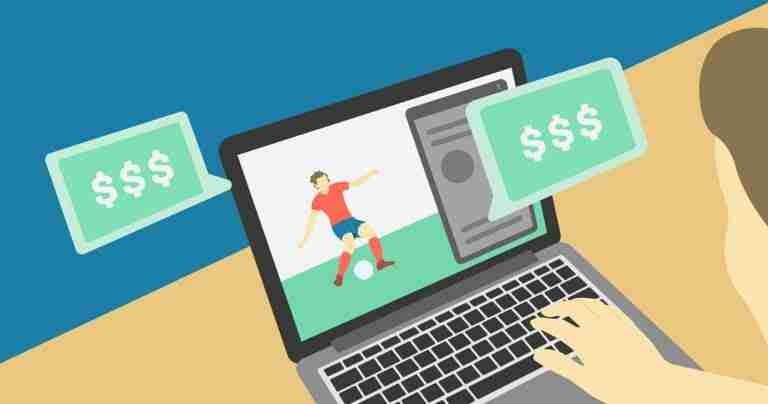 A person is watching a soccer match on their laptop while contemplating online betting options. matched betting guide