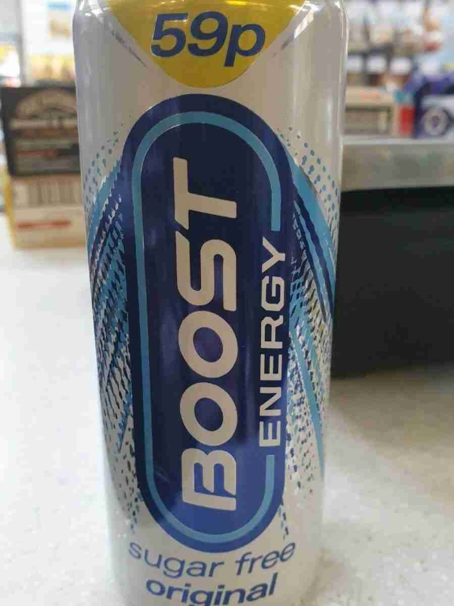 A can of "boost energy" sugar-free original flavor energy drink with a price tag of 59 pence, displayed on a sales counter with various items in the background. matched betting price boosts.